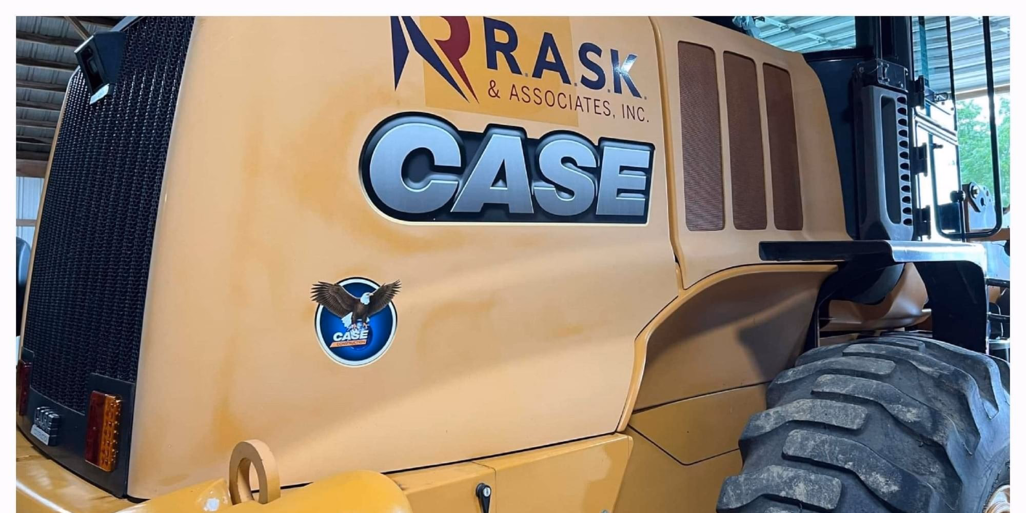 Factory finish: Case wheel loader hood, before and after multi-stage paint correction by Cecil